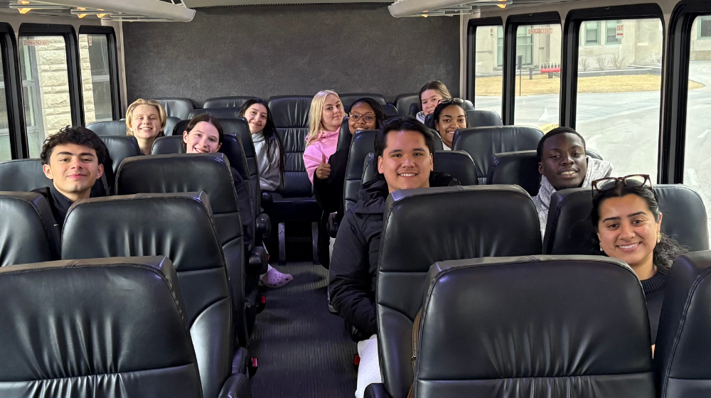 Students sit on a shuttle bus bound for O'Hare Airport.